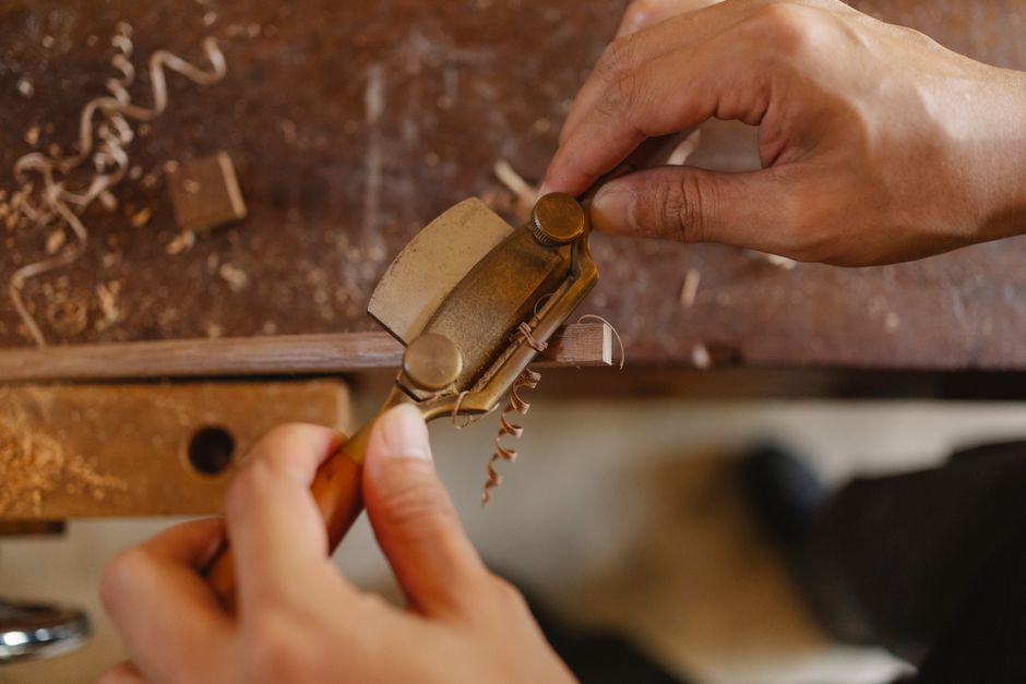 Craftsman shaping wood in the custom furniture maker workshop